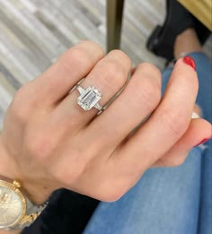 a woman's hand with a diamond ring on it