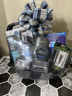 a gift basket with men's care products on top of a tiled countertop