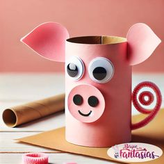 a paper roll pig with googly eyes on it