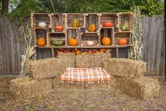 hay bales stacked on top of each other with pumpkins in the background