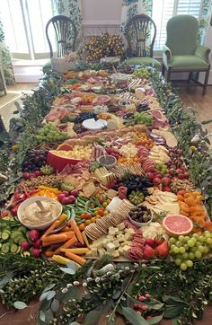 a long table filled with lots of different types of food and fruit on it's sides