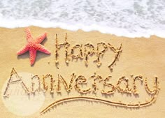 happy anniversary written in the sand with a starfish on it's side and an ocean wave