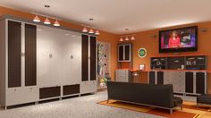 an orange and gray room with lockers, television, and couch