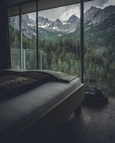 the instagram page shows an image of mountains and trees from inside a bedroom window