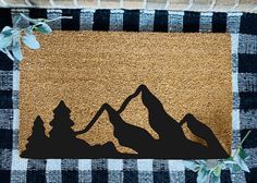 a door mat with the silhouette of mountains on it