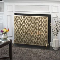 a living room with a fire place and vases