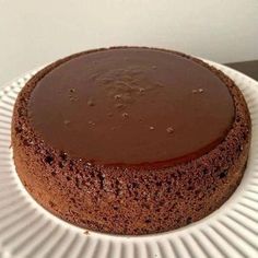 a chocolate cake sitting on top of a white plate