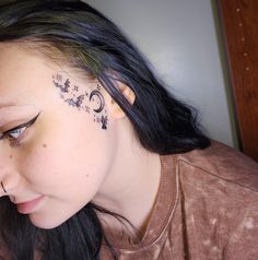 a woman with a butterfly tattoo on her forehead