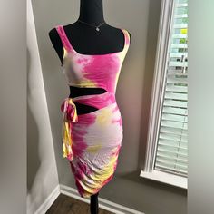 a mannequin is dressed up in a pink and yellow tie - dye dress