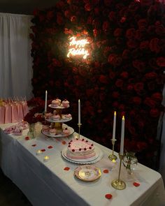 a table topped with lots of cakes and cupcakes