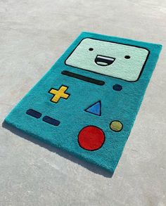 a rug that looks like a cartoon character is on the ground with an odd face