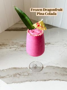 a pink drink with a pineapple garnish on top