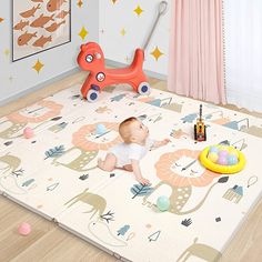 a baby is sitting on the floor in front of a play mat with an animal theme