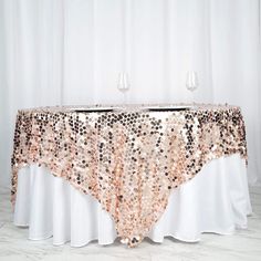 a table covered in sequins next to two wine glasses