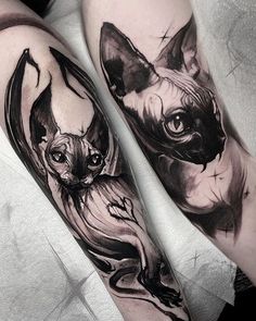 black and white cat tattoo on both legs