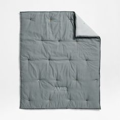 an open gray blanket with the word amr on it's side and a white background