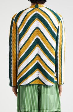 a woman wearing green and yellow striped sweater