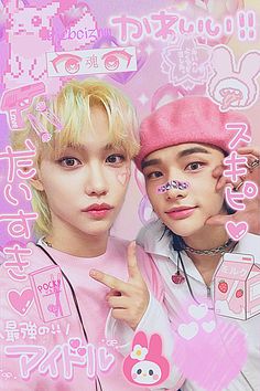 two young men with pink hair and piercings on their faces, one pointing at the camera