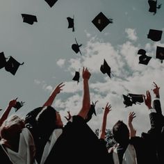 graduates throwing their caps in the air