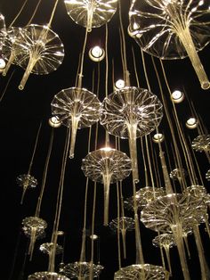 the lights are hanging from the ceiling made of glass vases and chandeliers