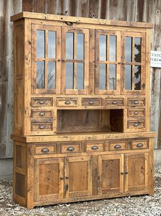 an old wooden cabinet with glass doors and drawers