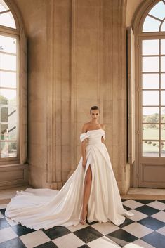 a woman in a white dress posing for a photo