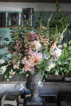 a vase filled with lots of flowers on top of a table