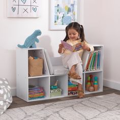 The KidKraft Bookcase with Reading Nook is popular with parents because of its clever design, sturdy construction and aesthetic appeal. Combining a cushioned seating area with bookshelves gives you two spaces in one furniture piece. Kids can store books, toys, blankets and more in the six shelves, then curl up on the three-sided angled middle section to read or rest. The two tall shelves on the sides are perfect for accommodating taller picture books. Place a lamp on the top sides for cozy light. Three gray cushions stay securely onto the base with self-adhesive strips. Available in trend-right colors to match your home's décor, the Bookcase with Reading Nook will help keep any kids room or playroom organized and neat. Crafted of premium, recyclable materials for long-lasting play Recommen Toy Nook, Baby Room Montessori, Bookcase Aesthetic, Playroom Decorations, Kids Storage Shelves, Libra Sign Tattoos, Toddler Storage, Kids Clubhouse, Loft Playroom