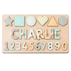 a wooden sign that says charlie and has numbers, shapes, and stars on it