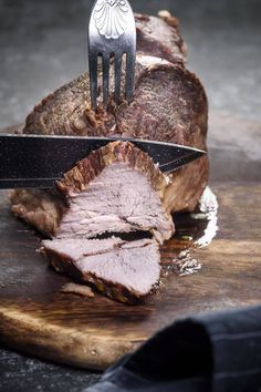 a knife and fork stuck into some meat