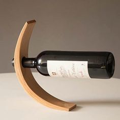 a bottle of wine sitting on top of a wooden stand