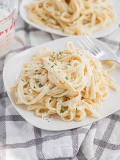 two plates of pasta with parmesan cheese sauce