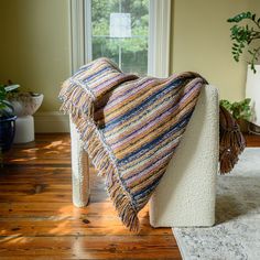 a blanket draped on the back of a chair