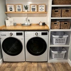 a washer and dryer in a laundry room with baskets on the shelves next to them