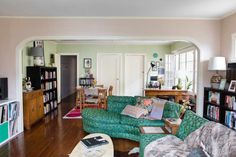 a living room filled with furniture and bookshelves