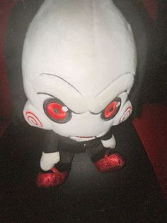 an evil looking stuffed animal with red eyes