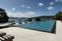 an empty swimming pool next to the ocean