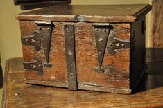 an old wooden box sitting on top of a table