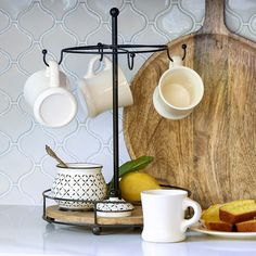 there is a tray with tea cups and bread on it