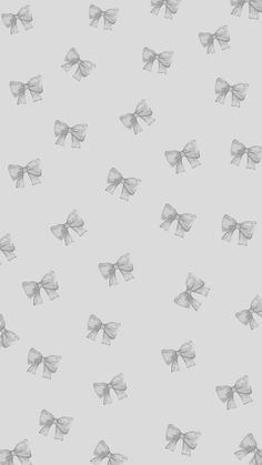 an image of many bows on a gray background for wallpaper or wrapping paper that can be used as a pattern