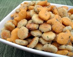 a white bowl filled with fried food sitting on top of a green cloth covered table