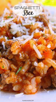 spaghetti and rice on a plate with parmesan cheese in the background text reads spaghetti rice