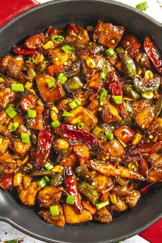 a skillet filled with chicken and peppers