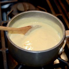 a wooden spoon is in a pot on the stove