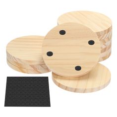 three wooden coasters with black dots on them