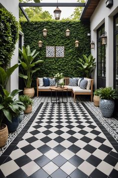 a black and white tiled patio with potted plants on either side, two benches at the end