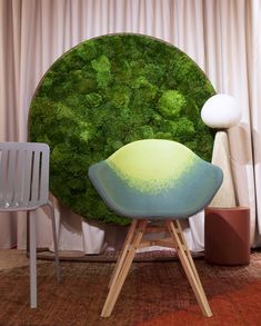 a chair sitting in front of a moss covered wall