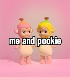 two small toy figures with the words me and pookiie on them in front of a pink background