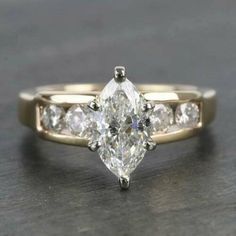 an engagement ring with three pear shaped diamonds