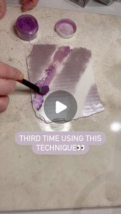 someone is painting something with purple paint on the counter and it says, third time using this technique